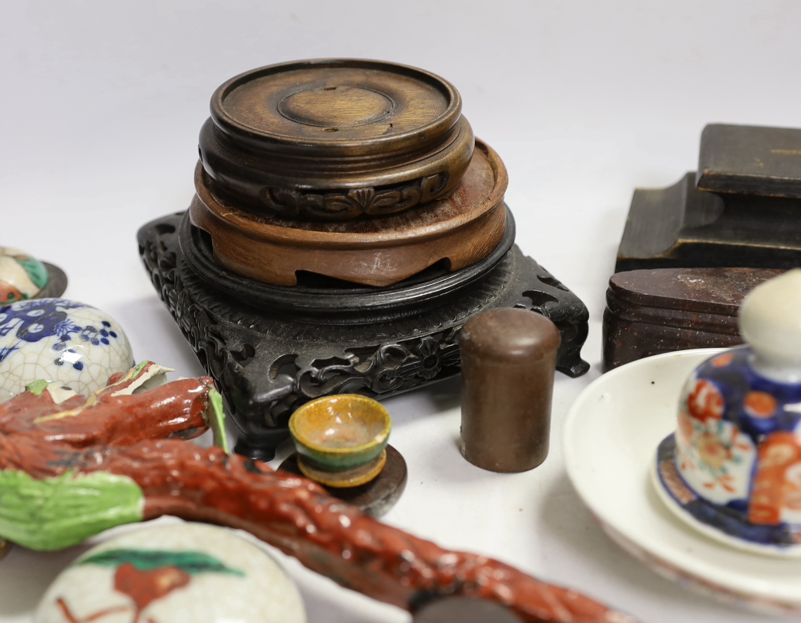 A collection of mixed Chinese wooden stands, a ceramic dragon head and miscellaneous ceramics